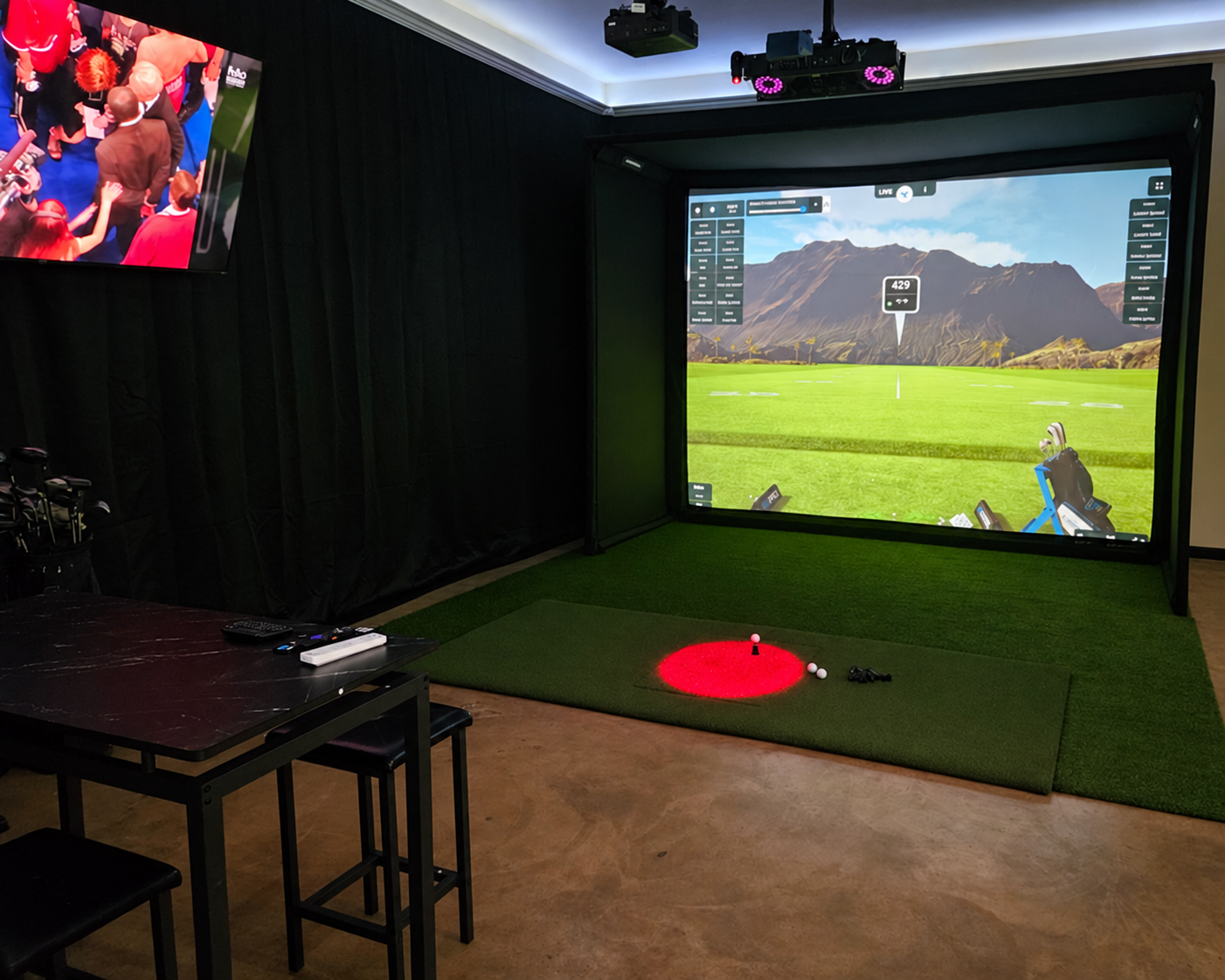 BAY 2 at Mulligan Bay Golf, with its ProTee VX simulator, hitting area, TVs and seating.